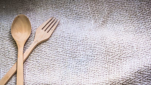 Male hands hold a fork over blur green background for food cooking