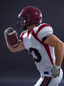 American football Player running with the ball isolated on a gray background