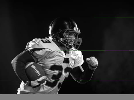 American football player holding ball while running on field at night