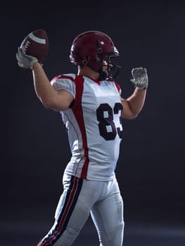 one quarterback american football player throwing ball isolated on gray background