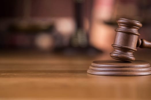 Law theme, mallet of judge, wooden gavel, globe background