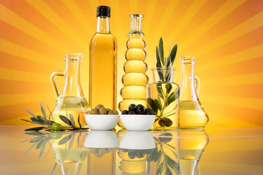 Bottles with organic cooking olive oil and olive branch