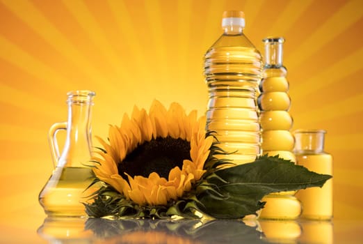 Sunflower oil, olive oil on sunburst orange background