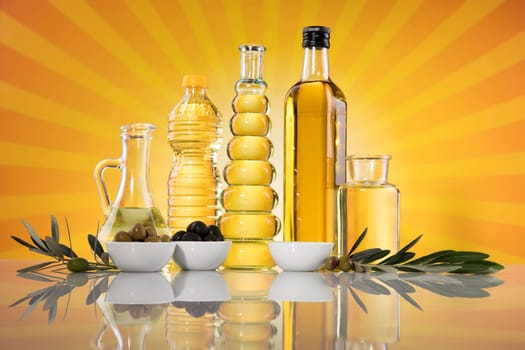 Bottles with organic cooking olive oil and olive branch