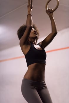 Fitness dip ring beautiful young african american woman workout at gym dipping exercise