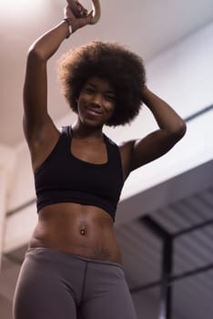 Fitness dip ring beautiful young african american woman workout at gym dipping exercise
