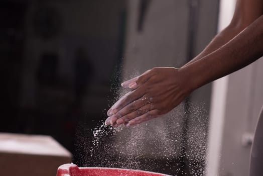 Gym Chalk Magnesium Carbonate hands clapping young african american woman for climbing workout
