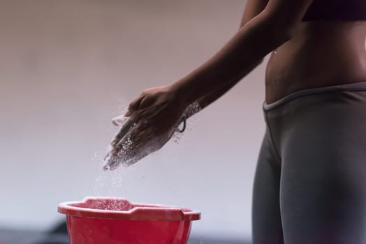 Gym Chalk Magnesium Carbonate hands clapping young african american woman for climbing workout