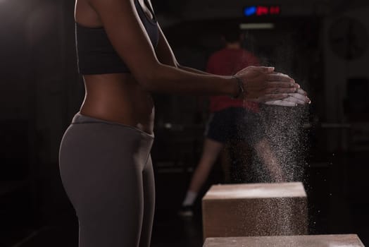 Gym Chalk Magnesium Carbonate hands clapping young african american woman for climbing workout