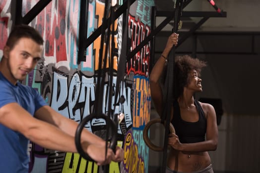 dip ring young man and african american woman relaxed after workout at gym dipping exercise