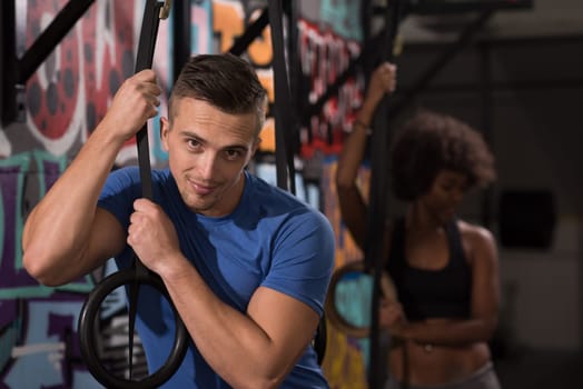 dip ring young man and african american woman relaxed after workout at gym dipping exercise