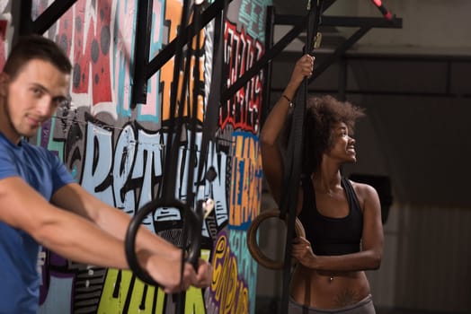 dip ring young man and african american woman relaxed after workout at gym dipping exercise
