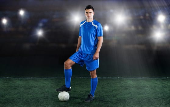 soccer player doing kick with ball on football stadium  field  isolated on black background
