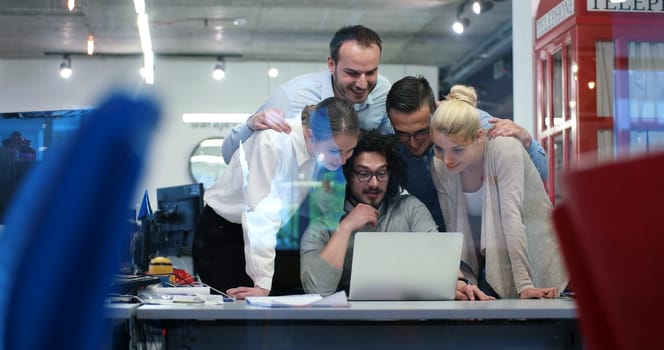 Group of a young business people discussing business plan at modern startup office building