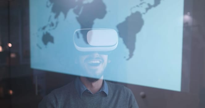 happy man getting experience using VR-headset glasses of virtual reality at home
