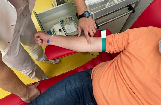 Close up nurse hand collecting blood sample for diagnosis covid-19, Coronavirus.Laboratory technician taking blood for blood chemistry diagnosis by automatic machine. High quality photo