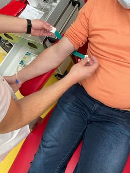 Close up nurse hand collecting blood sample for diagnosis covid-19, Coronavirus.Laboratory technician taking blood for blood chemistry diagnosis by automatic machine. High quality photo