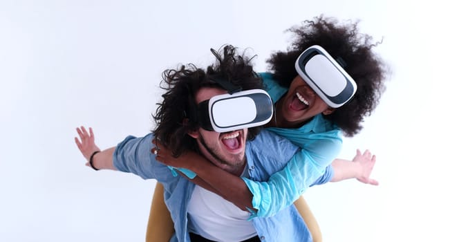 Happy multiethnic couple getting experience using VR headset glasses of virtual reality, isolated on white background