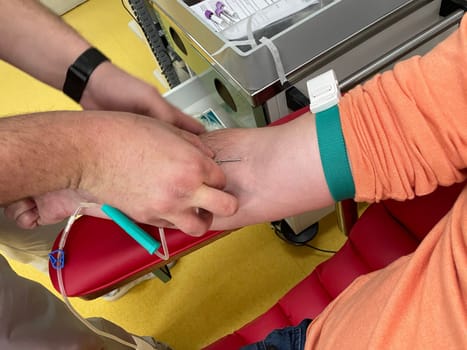 Close up nurse hand collecting blood sample for diagnosis covid-19, Coronavirus.Laboratory technician taking blood for blood chemistry diagnosis by automatic machine. High quality photo