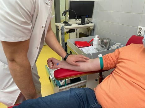 Close up nurse hand collecting blood sample for diagnosis covid-19, Coronavirus.Laboratory technician taking blood for blood chemistry diagnosis by automatic machine. High quality photo