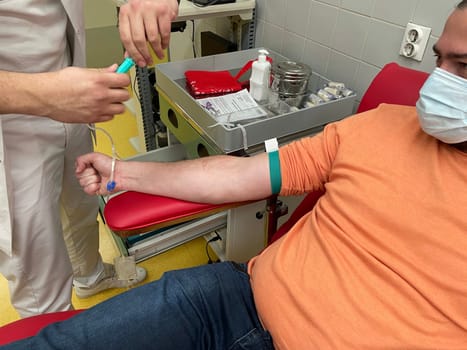 Close up nurse hand collecting blood sample for diagnosis covid-19, Coronavirus.Laboratory technician taking blood for blood chemistry diagnosis by automatic machine. High quality photo