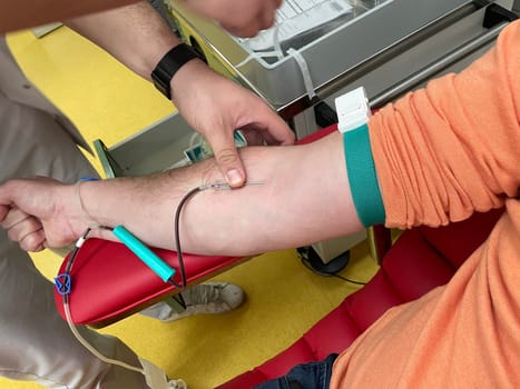 Close up nurse hand collecting blood sample for diagnosis covid-19, Coronavirus.Laboratory technician taking blood for blood chemistry diagnosis by automatic machine. High quality photo