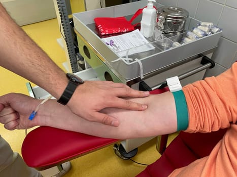 Close up nurse hand collecting blood sample for diagnosis covid-19, Coronavirus.Laboratory technician taking blood for blood chemistry diagnosis by automatic machine. High quality photo