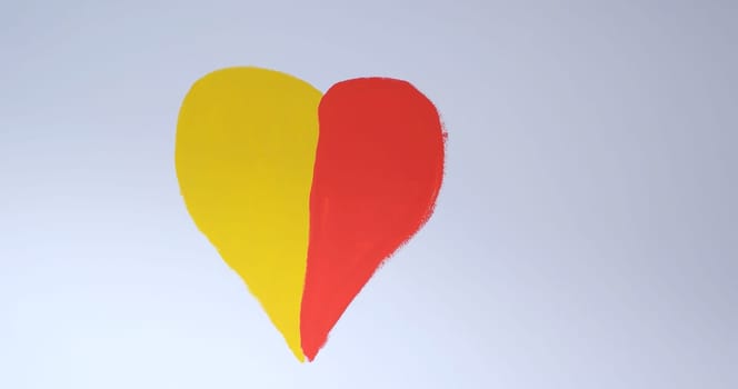 red and yellow heart on a white wall