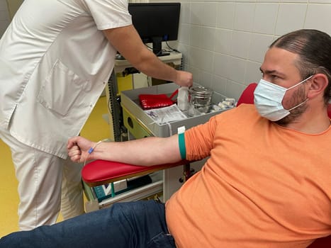Close up nurse hand collecting blood sample for diagnosis covid-19, Coronavirus.Laboratory technician taking blood for blood chemistry diagnosis by automatic machine. High quality photo