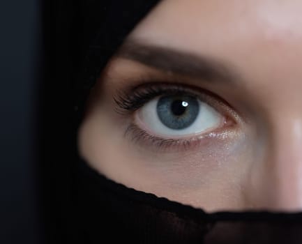 Portrait of muslim woman wearing niqab and traditional arabic clothes or abaya. Arab woman representing modern arabic lifestyle, islamic fashion and Ramadan kareem concept