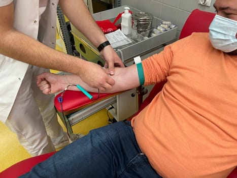 Close up nurse hand collecting blood sample for diagnosis covid-19, Coronavirus.Laboratory technician taking blood for blood chemistry diagnosis by automatic machine. High quality photo