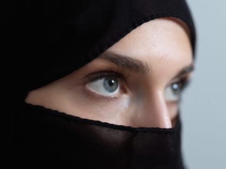 Portrait of muslim woman wearing niqab and traditional arabic clothes or abaya. Arab woman representing modern arabic lifestyle, islamic fashion and Ramadan kareem concept