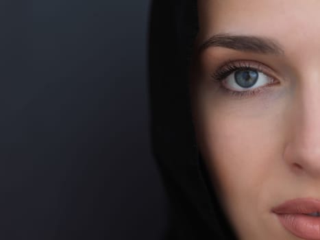 Portrait of modern young muslim woman in black abaya. Arab girl wearing traditional clothes and posing in front of black chalkboard. Representing modern and rich arabic lifestyle