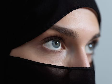 Portrait of muslim woman wearing niqab and traditional arabic clothes or abaya. Arab woman representing modern arabic lifestyle, islamic fashion and Ramadan kareem concept