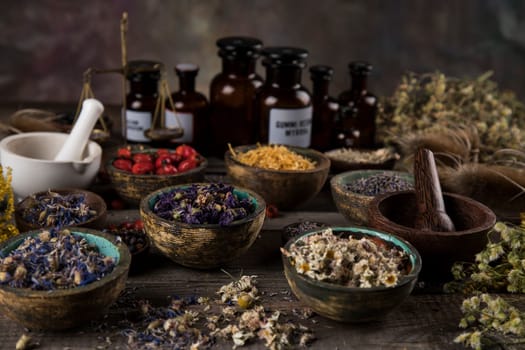 Alternative health, fresh herbal and mortar on wooden background
