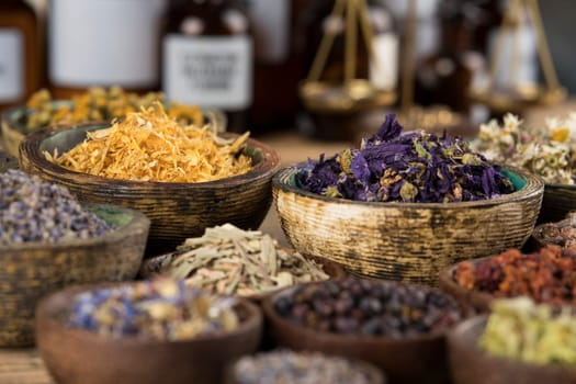 Homeopathy, herbal medicine on wooden table