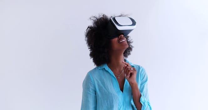 Happy african american girl getting experience using VR headset glasses of virtual reality, isolated on white background