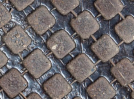 The blurred Detail of the pattern from a manhole cover
