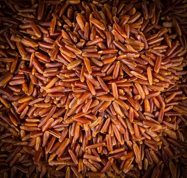 The close up texture of raw brown rice. Background.