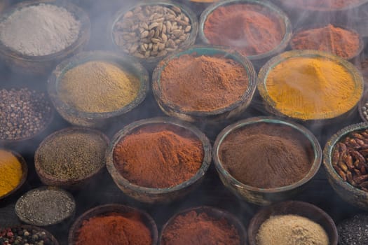 Smoke, Aromatic spices on wooden background