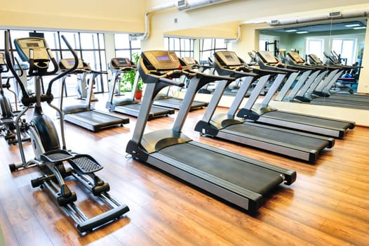 Set of treadmills staying in line in the gym
