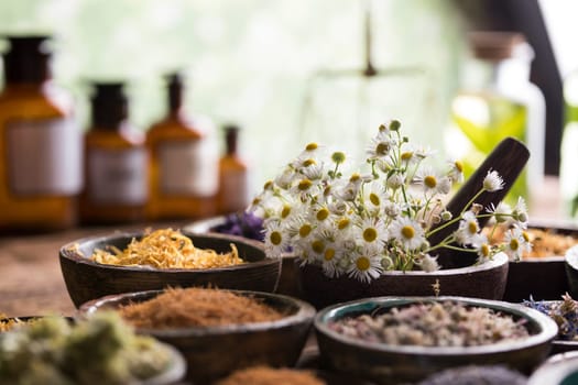 Homeopathy, herbal medicine on wooden table