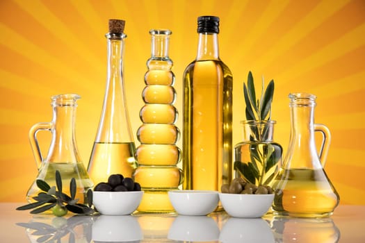 Bottles with organic cooking olive oil and olive branch