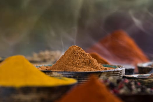 Smoke, Aromatic spices on wooden background