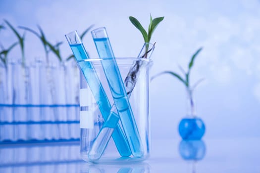 Laboratory beakers, microscope, blue background