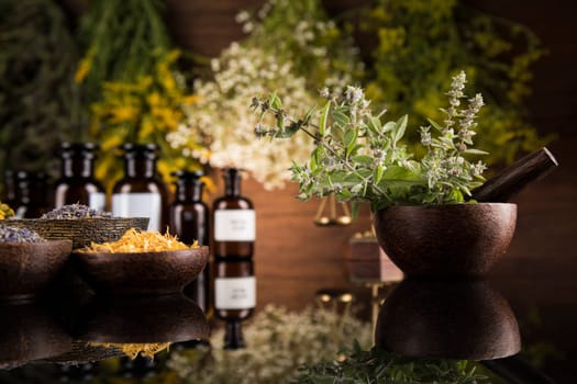 Alternative health, fresh herbal and mortar in black mirror background