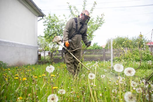 Mowing the grass with a lawn mower. Garden work concept background.