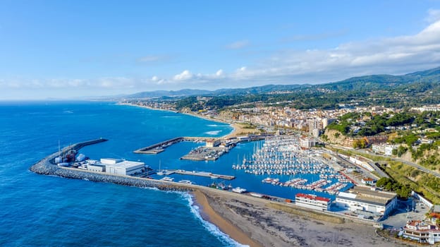 Aerial panoramic view of Arenys de Mar city at dawn. Located in El Maresme, Barcelona, Spain