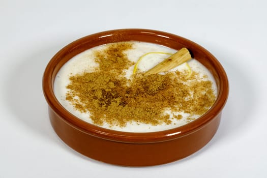 Dish of rice pudding with grated cinnamon, with lemon scratches