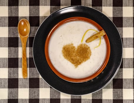 Dish of rice pudding with grated cinnamon, with cinnamon heart detail